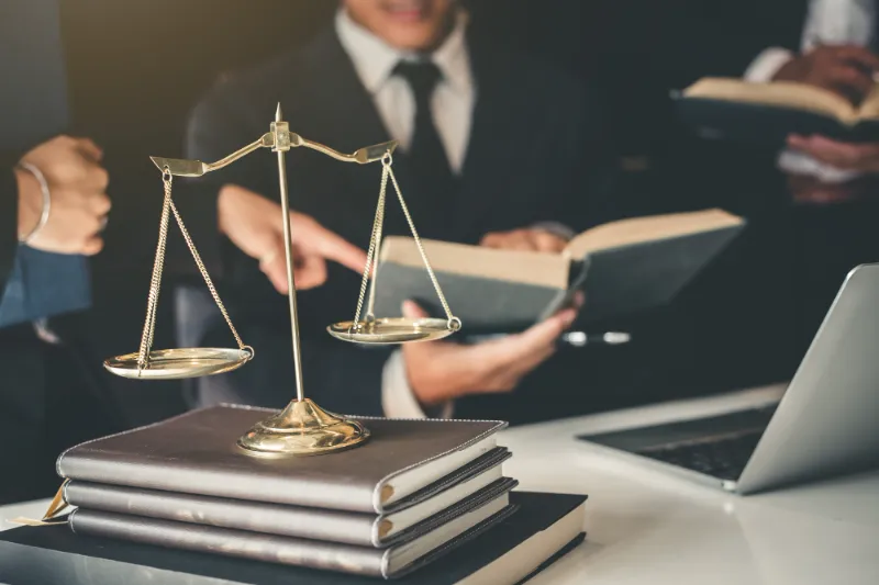 Expert legal team working together on settlement agreement negotiations for expats in the Netherlands